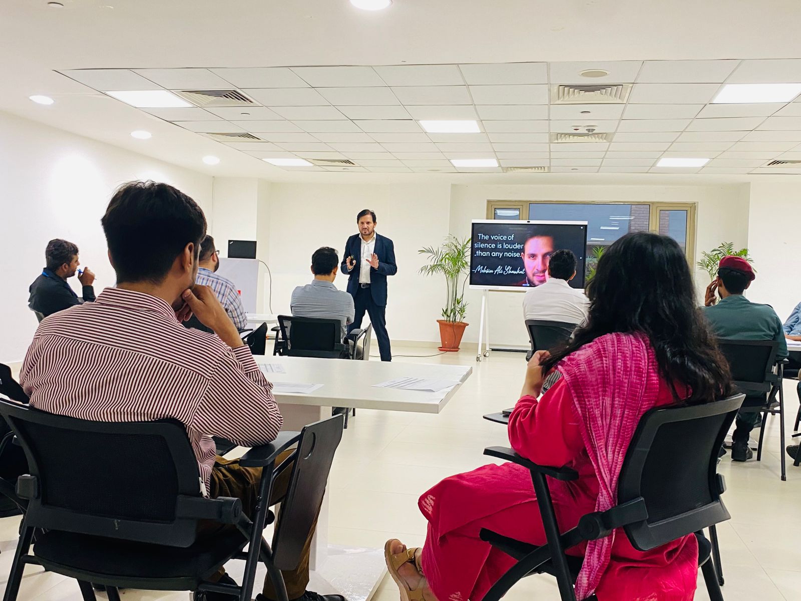 Facilitated workplace learning session with participants in a training room